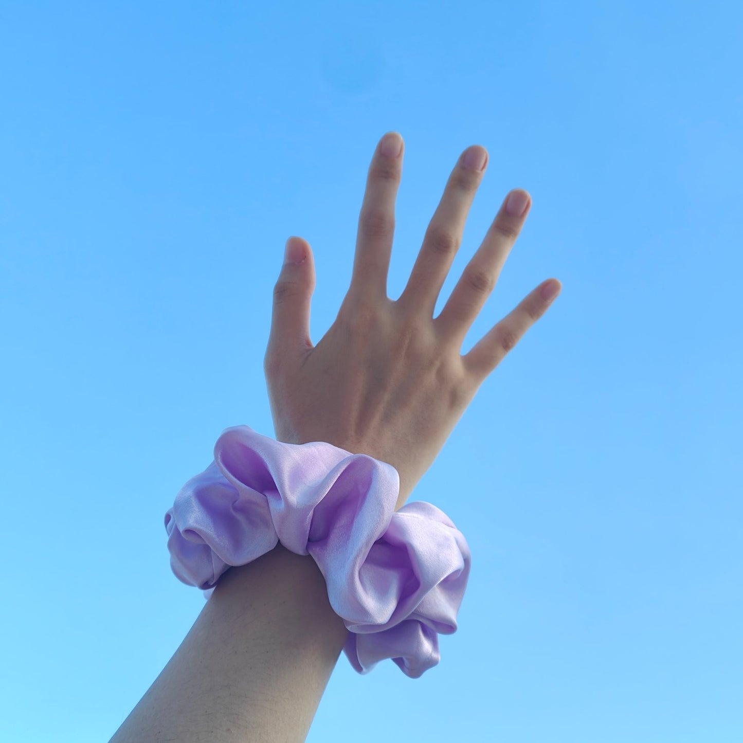 Amirah scrunchie worn around wrist