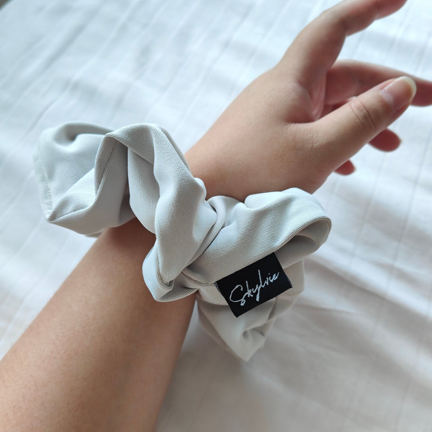 Angela sports scrunchie around wrist
