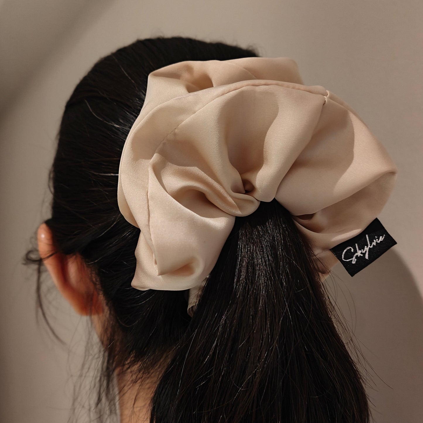 Emma scrunchie tied around hair