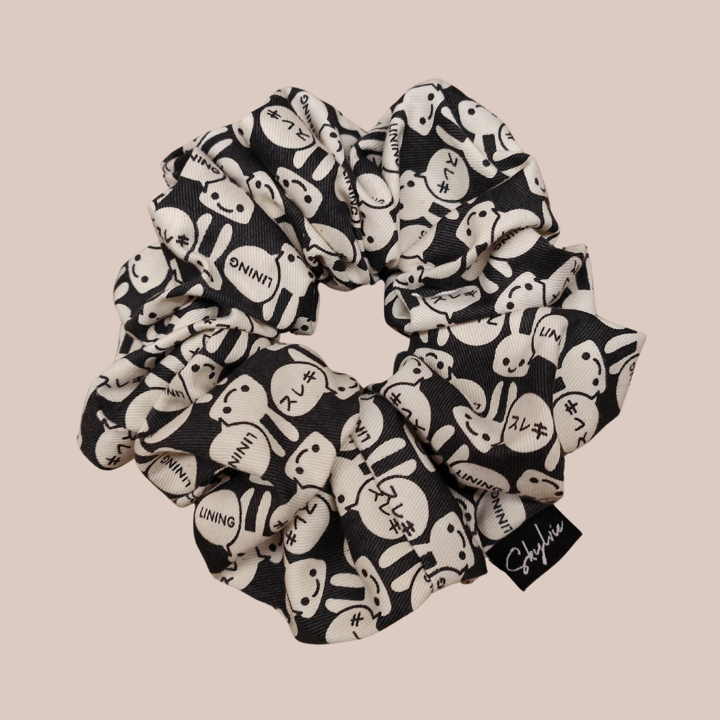 Mia Scrunchie, a black scrunchie with white bunnies
