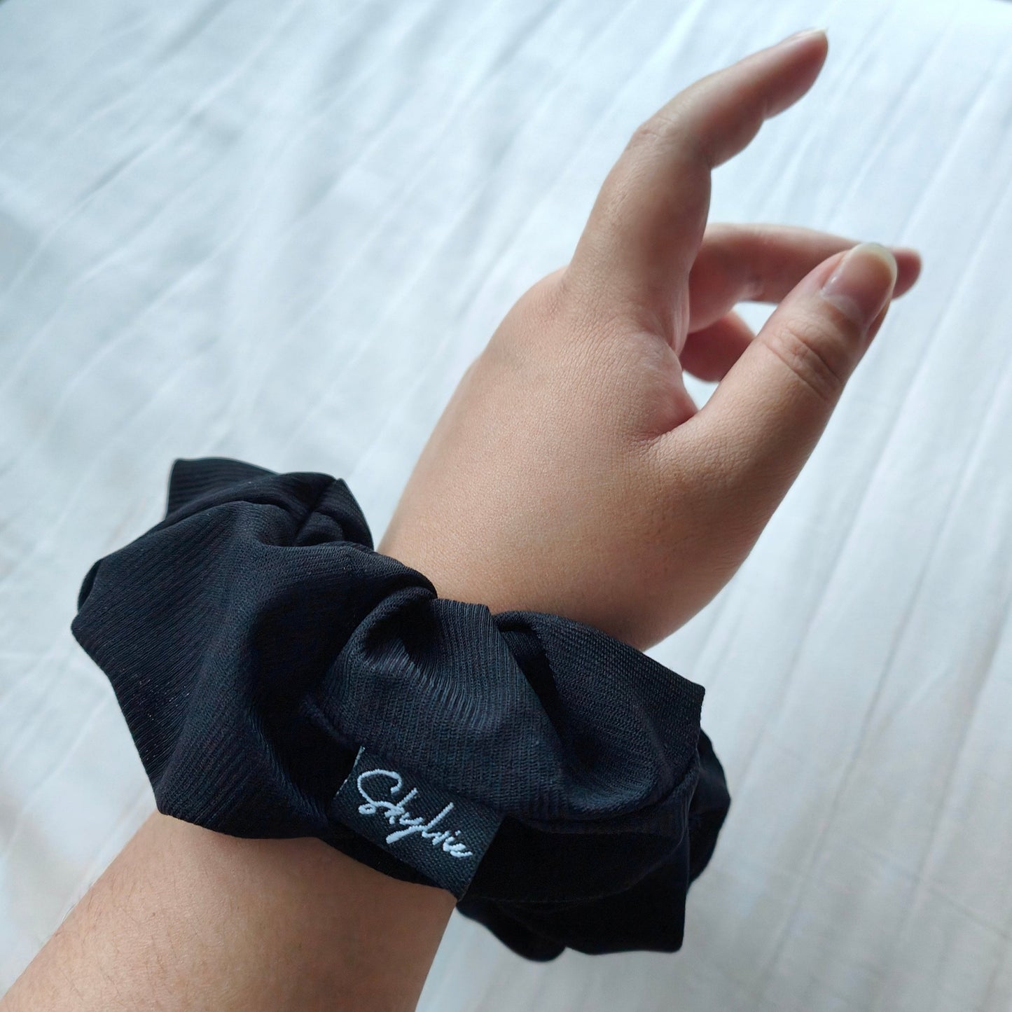 Natalie, black sports scrunchie, on wrist